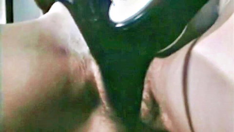 Bound woman in tight BDSM leather restraints exposing crotch