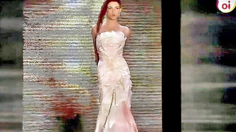 Redhead model in elegant white floral gown on BDSM fashion runway tease