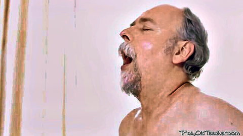 Balding older man with gray mustache, mouth open in ecstasy, naked upper body in steamy seduction scene