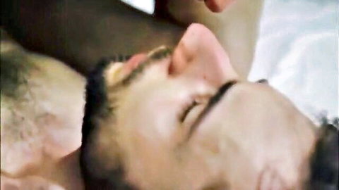 Bearded hairy-chested gay man in romantic close embrace, eyes closed blissfully