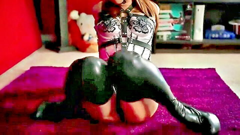 Bound Asian in white harness, black latex pants, boots, gagged kneeling BDSM