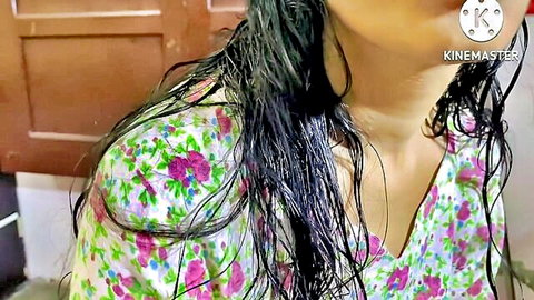 Wet South Asian woman in floral dress with soaked hair teasing cleavage