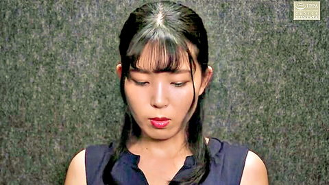 Close-up of sexy Japanese babe with bangs and red lips looking down in sleeveless top