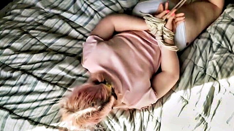 Cute blonde with fat ass tied up in BDSM pose on bed, teaser
