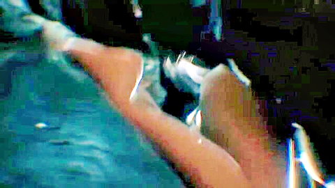 Blurry close-up of woman's legs in white stockings in water