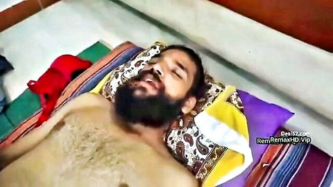 Bearded Desi man lying shirtless on bed in Bhabhi Devar MILF scene