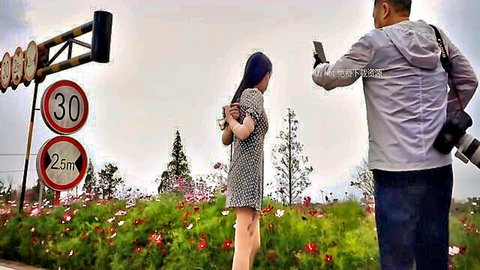 Asian woman in short dress, hands bound behind back, outdoor BDSM street tease photo