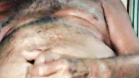 Hairy mature man gripping his thick cock in closeup handjob view
