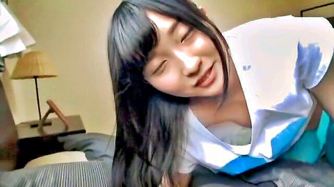 Seductive Japanese amateur idol teasing with cleavage in white top