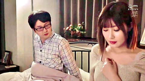 Asian couple in intimate bedroom scene, woman in off-shoulder sweater, man in checkered shirt