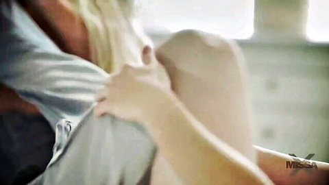 Blonde MILF in gray top teases younger stud with intimate thigh touch