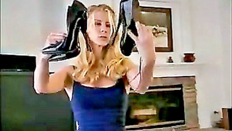 Blonde woman holding black high heel boots in BoundHub poker game scene