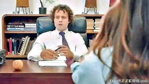 Curly-haired boss in suit faces mysterious woman in office exam seduction scene