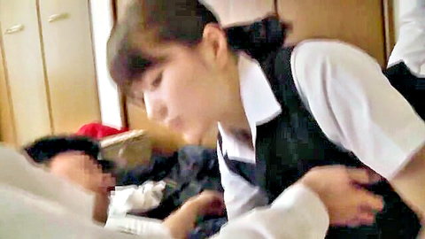 Cute Asian schoolgirl in uniform leans over brother on bed, intimate touch