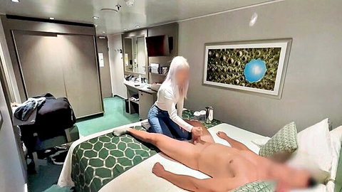 Blonde in jeans massages naked man's exposed cock on hotel bed