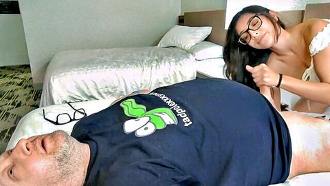 Petite brunette teen in glasses gropes older man's thigh and balls on hotel bed after cumshot