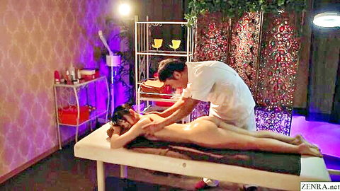 Clothed Japanese masseur oils and massages nude big ass woman's bare buttocks on table