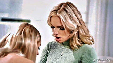 Two sexy blondes with long hair staring intensely lips close in lesbian kiss tease