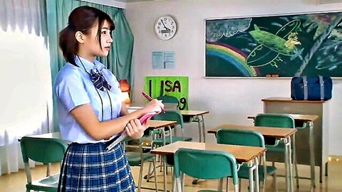 Japanese schoolgirl in uniform holding notebook in classroom, threesome preview