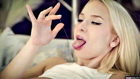 Vera Jarw blonde bombshell teasing with tongue out in white top