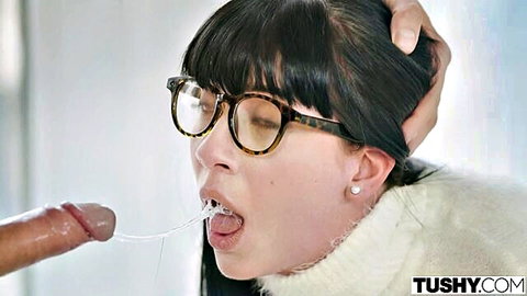 Asian woman with glasses and bangs gets cumshot in mouth during blowjob