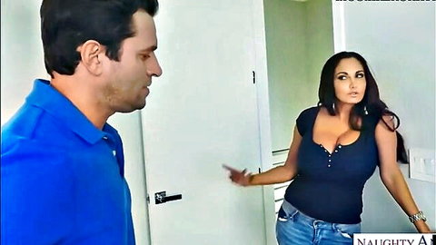 Busty brunette MILF in low-cut top showing huge cleavage flirts with handsome stud by bathroom door