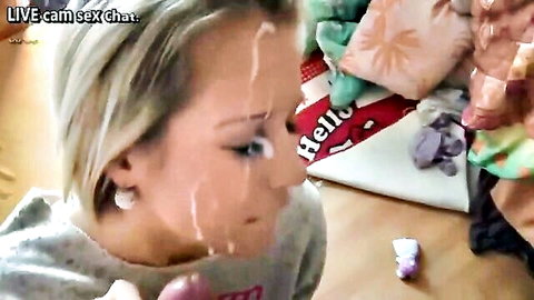 Blonde woman with facial cumshot holding dildo at home orgy college party