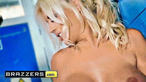 Blonde with huge fake tits exposes massive bare breasts and nipples in locker room
