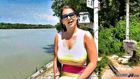 Anissa Jolie with huge tits in white tank top, teasing outdoors by river
