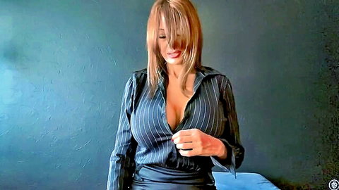 Blonde MILF in pinstripe shirt unbuttons deep cleavage showing massive fake tits