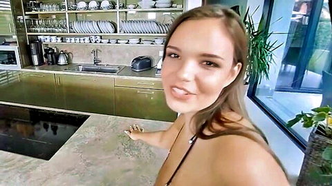 Young curvy brunette with huge tits teases smiling in kitchen POV