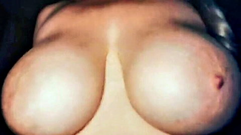 Topless woman with large natural breasts in close-up view