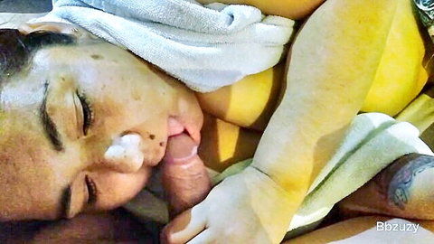 Latina woman giving intense blowjob, eyes closed, wrapped in towel