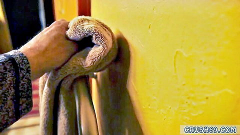 Hand wiping yellow wall with towel in taboo daddy tension relief scene