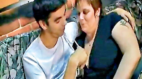 Young man intimately embraces busty mature BBW in black top