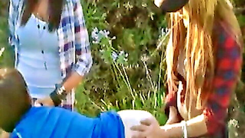 Outdoor threesome with mean girls in plaid shirts using strap-ons on guy