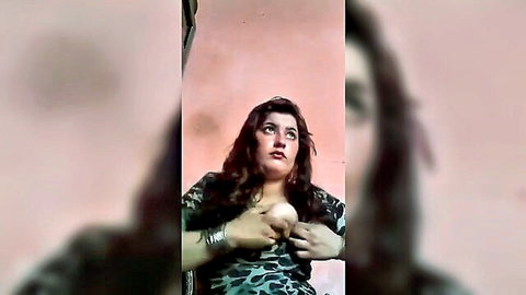 Sensual Pakistani babe with big tits squeezes deep cleavage in erotic solo tease