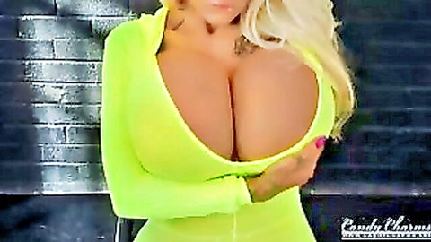 Candy Charms blonde with massive boobs unzips yellow top in striptease
