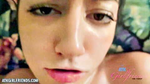 Close-up of Asian model Lily's seductive face and bare shoulder in squirting video