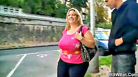 Busty blonde BBW shows off huge tits in tight pink top walking street with guy