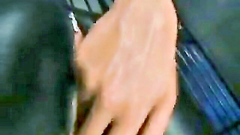 Asian bondage fetishist exposing big round tits in fetish scene