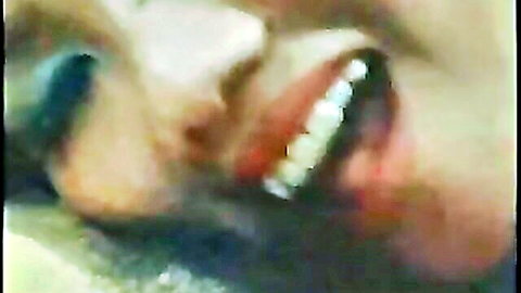 Vintage blonde bombshell with mouth wide open showing teeth and tongue in retro closeup