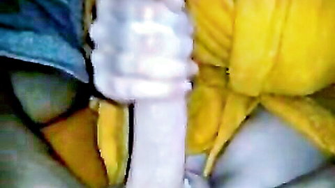 Blurry amateur POV closeup of thick white cock gripped near yellow fabric and skin