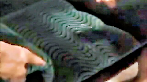 Blurry close-up of fingers fingering pussy with green wavy panties pulled aside