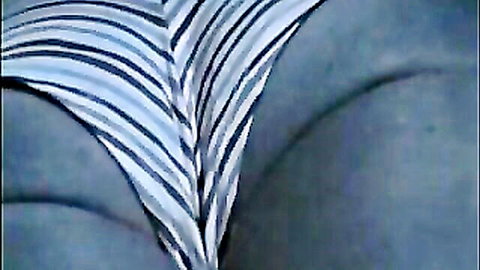Closeup of juicy ass cheeks squeezed in tight striped panties