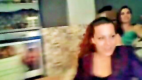 Curvy redhead and brunette women in casual tops chatting on amateur livecam