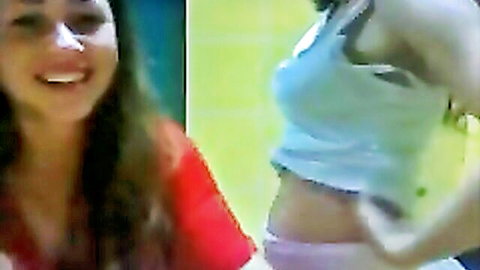 Gabi and Nati twin sisters teasing, one lifting crop top to show underboob and pink panties