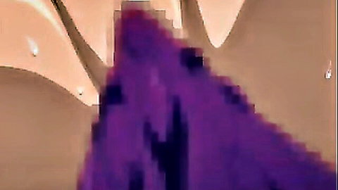 Mysterious woman in flowing purple dress under dramatic lights