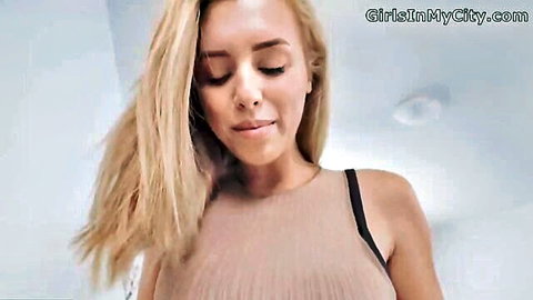Seductive blonde in beige tank top, daring gaze close-up