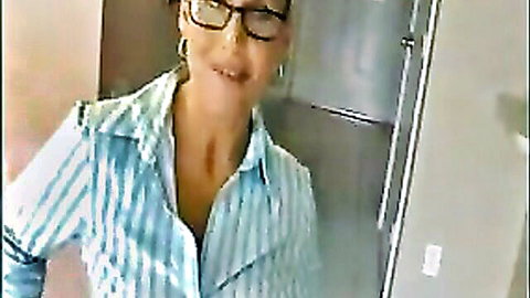 Curious MILF in open striped blouse smiling with cleavage tease